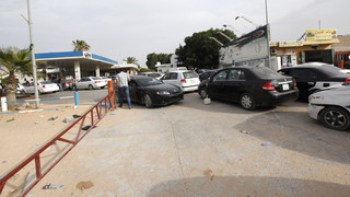 Vehicles line up at a petrol station in the capital Tripoli