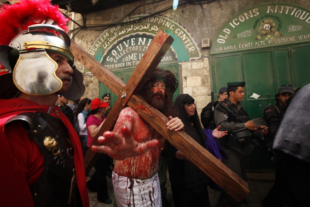 Christians worshippers take part in a Good Friday procession on the Via Dolorosa