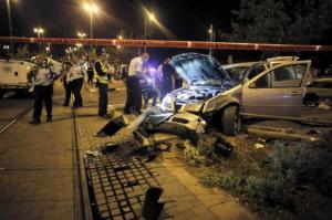 Israeli policemen inspect a car wreck in Jerusalem