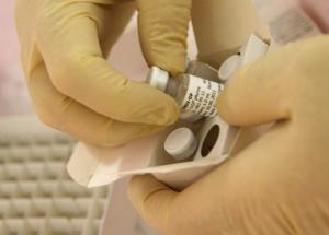Scientists at the National Microbiology Lab in Winnipeg, Manitoba, prepare an experimental Ebola vaccine for shipment to the World Health Organization (WHO) in Geneva in this undated handout picture released