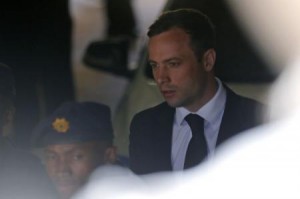 South African Olympic and Paralympic sprinter Oscar Pistorius is led to a prison van after his sentencing in Pretoria