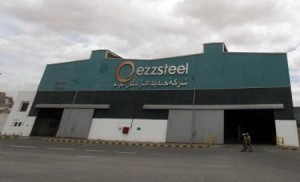 Workers walk in front of a factory belonging to Ezz Steel, Egypt"s largest steel producer, at an industrial complex in Sadat City, 94 km (58 miles) north of Cairo