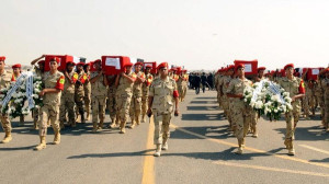 Soldiers carry the coffins of fellow soldiers killed in a suicide attack in Sinai on Friday during a military funeral in Cairo