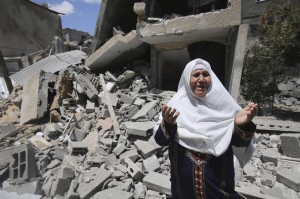 A Palestinian woman reacts in front of the remains of her house, which police said was destroyed in an Israeli air strike, in Rafah in the southern Gaza Strip