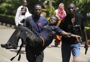 A-Kenyan-woman-is-helped-to-safety-after-masked-gunmen-stormed-an-upmarket-mall-and-sprayed-gunfire-on-shoppers-and-staff