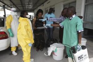 A health worker sprays a colleague with disinfectant during a training session for Congolese health workers to deal with Ebola virus in Kinshasa 