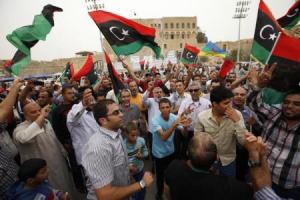 Libyans celebrate after the Supreme Court invalidated the country"s parliament, at Martyrs" Square in Tripoli 