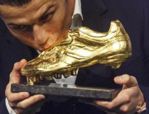 Real Madrid"s Cristiano Ronaldo kisses his Golden Boot trophy during a ceremony in Madrid