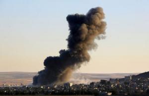 Thick black smoke rises over an eastern Kobani neighborhood following an airstrike