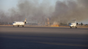 Smoke rises after a shelling at Tripoli International Airport