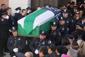 Pallbearers carry the casket for the funeral of slain New York Police Department (NYPD) officer Rafael Ramos at the Christ Tabernacle Church on December 27, 2014 in the Glenwood section of the Queens borough of New York City.