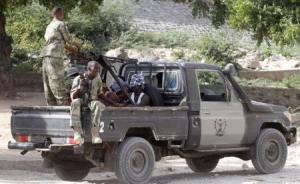 Somalia security forces transport blind-folded suspects detained on their pick-up truck after attackers from the militant group al Shabaab invaded the African Union"s Halane base on the edge of the Mogadishu international airport compound in Somalia"s capital Mogadish