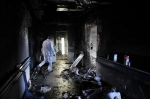 A hospital staff inspects the damage at the Benghazi Medical Center after a shell hit the sixth floor causing a fire in part of the building, according to the security office at the hospital, in Benghazi