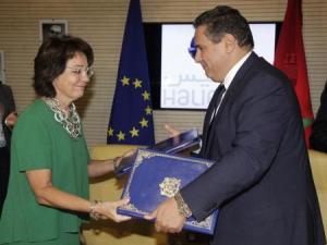 Maria Damanaki (L), the European Commissioner for Maritime Affairs and Fisheries, and Aziz Akhannouch (R), minister of Agriculture and Fisheries, exchange documents after signing them as part of bilateral fisheries partnership agreements in Rabat