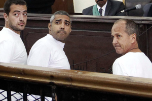 Al-Jazeera English producer Baher Mohamed (l.), Canadian-Egyptian acting Cairo bureau chief Mohammed Fahmy (c.), and correspondent Peter Greste