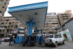 People are seen at a petrol station in Cairo