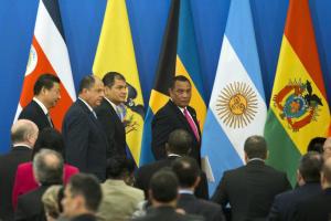 From left, Chinese President Xi Jinping, Costa Rica's President Luis Guillermo Solis, Ecuador's President Rafael Correa and Bahamas Prime Minister Perry Gladstone Christie leave after the opening ceremony to a two-day meeting between China and Latin American and Caribbean countries held at the Great Hall of the People in Beijing, China