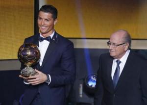 Real Madrid"s Cristiano Ronaldo of Portugal, holds his World Player of the Year trophy as he stands next to FIFA President Sepp Blatter