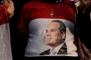An Egyptian Christian woman wearing a shirt with the photo of Egyptian President Abdel Fattah el-Sissi during a vigil to morn Christians who were killed in Libya, at St. Mark's Cathedral in Cairo