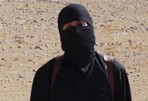 This undated image shows a frame from a video released Friday, Oct. 3, 2014, by Islamic State militants that purports to show the militant who beheaded of taxi driver Alan Henning . A British-accented militant who has appeared in beheading videos released by the Islamic State group in Syria over the past few months bears "striking similarities" to a man who grew up in London