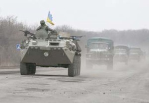 Members of the Ukrainian armed forces ride on an armoured personnel carrier near Artemivsk, eastern Ukraine