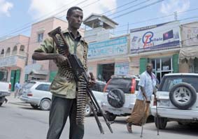 Somali federal government forces patrol a street of Mogadishu on February 18, 2015, during an operation against Al-Shebab insurgents
