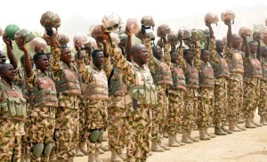Picture shows soldiers fighting Boko Haram Islamists cheering Nigerian President Goodluck Jonathan on his arrival in Mubi, recently recaptured from insurgents