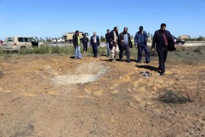 افراد امن ومسؤولون بقطاع الطيران يعاينون اثار هجوم على مطار معيتيقة في طرابلس