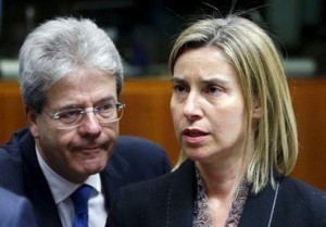 European Union foreign policy chief Federica Mogherini and Italian Foreign Minister Paolo Gentiloni (L) attend a meeting of European Union foreign and defence ministers at the EU Council in Brussels, Belgium