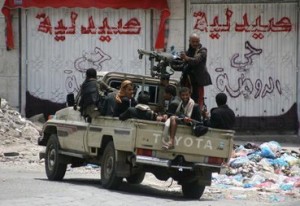 Abdel Rahman Abdallah - Armed tribal gunmen of the Popular Resistance Committees monitor a street in the southern city of Taez during ongoing clashes with Shiite Huthi rebels