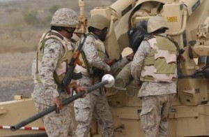Saudi soldiers load an artillery piece at a position close to the Saudi-Yemeni border, in southwestern Saudi Arabia