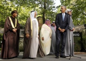 U.S. President Barack Obama looks back toward Oman Deputy Prime Minister Sayyid Fahd bin Mahmoud Al Said (L) and the Emir of Kuwait Sheikh Sabah Al-Ahmed Al-Jaber Al-Sabah (2nd L) while hosting the six-nation Gulf Cooperation Council (GCC) at Camp David in Maryland
