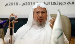 Youssef al-Qaradawi (R) speaks during a news conference in Doha