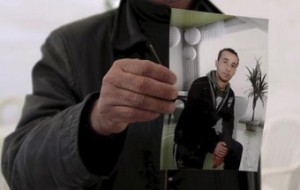 The cousin of Yassine al-Abidi, who gunned down 20 foreign tourists at Tunisia"s Bardo Museum, shows a photo of Yassine during an interview with Reuters in Tunis, Tunisi