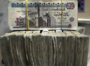 Go to Article Egypt"s pound notes are pictured in stacks of 100 as employees count money at an exchange office in downtown Cairo