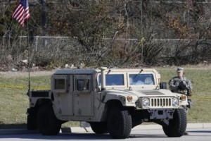 A National Guardsman stands by a humvee stationed across a mall in Ferguson, Missouri