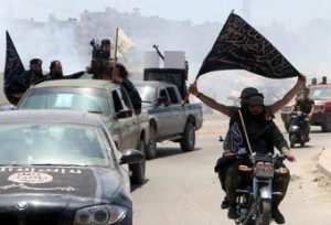 Fighters from Al-Qaeda's Syrian affiliate Al-Nusra Front drive in the northern Syrian city of Aleppo flying Islamist flags as they head to a frontline