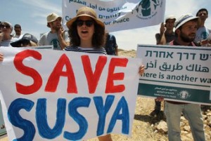 Protesters demonstrate against the demolition of the West Bank village of Susya