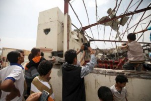 People take pictures of what remain of a wedding hall destroyed by a Saudi-led air strike in Yemen"s capital Sanaa