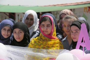 Nobel Peace Prize laureate Malala Yousafzai (C) poses with girls for a picture at a school for Syrian refugee girls, built by the NGO Kayany Foundation, in Lebanon"s Bekaa Valley
