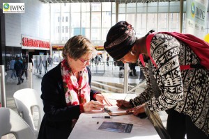 Woman signing to be a member of IWPG