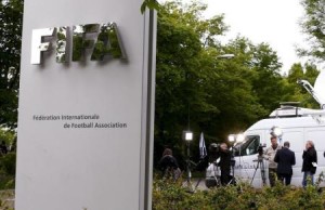 Members of the media stand in front of the entrance of the FIFA headquarters in Zurich
