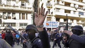 Masked policemen patrol the site of a bomb blast near the Egyptian High Court, in downtown Cairo