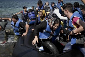 Refugees and migrants arrive on a dinghy after they crossed from Turkey to Lesbos island, Greece, 