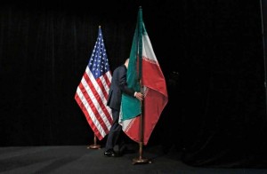 A worker removing the US and Iranian flags from the stage in Vienna on July 14, 2015 as foreign ministers came to a deal with iran on its nuclear programme
