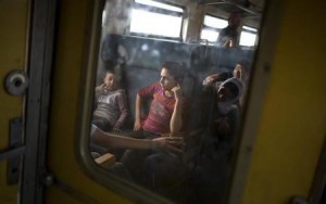Migrant children sit inside a train after crossing the Macedonian-Greek border near Gevgelija, Macedonia 