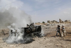 Civil defense members put out the flames on a burning military vehicle at a base controlled by rebel fighters from the Ahrar al-Sham Movement, that was targeted by what activists said were Russian airstrikes at Hass ancient cemeteries in the southern countryside of Idlib,