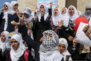 Palestinian students chant slogans during a rally to show solidarity with Palestinians clashing with the Israeli troops in the West Bank and Jerusalem, in Rafah