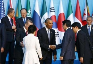 U.S. President Barack Obama shakes hands with Japan's Prime Minister Shinzo Abe as members of the Group of 20 (G20) prepare for the traditional family photo during the G20 leaders summit in the Mediterranean resort city of Antalya, Turkey