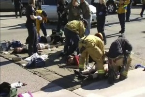 Rescue crews tend to the injured in the intersection outside the Inland Regional Center in San Bernardino, California in this still image taken from video 